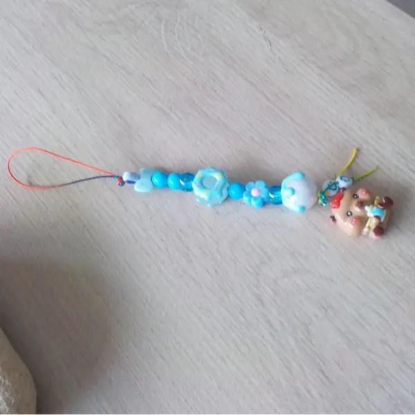 Bijou de telephone grigri de sac bébé capybara capibala mignon biberon perles acryliques donuts noeud papillon bleu fleurs